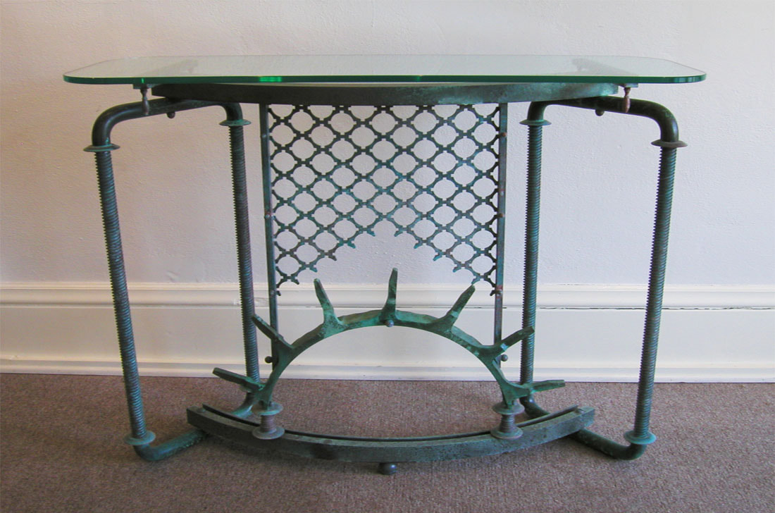 Glass topped console table with sculptural metal base